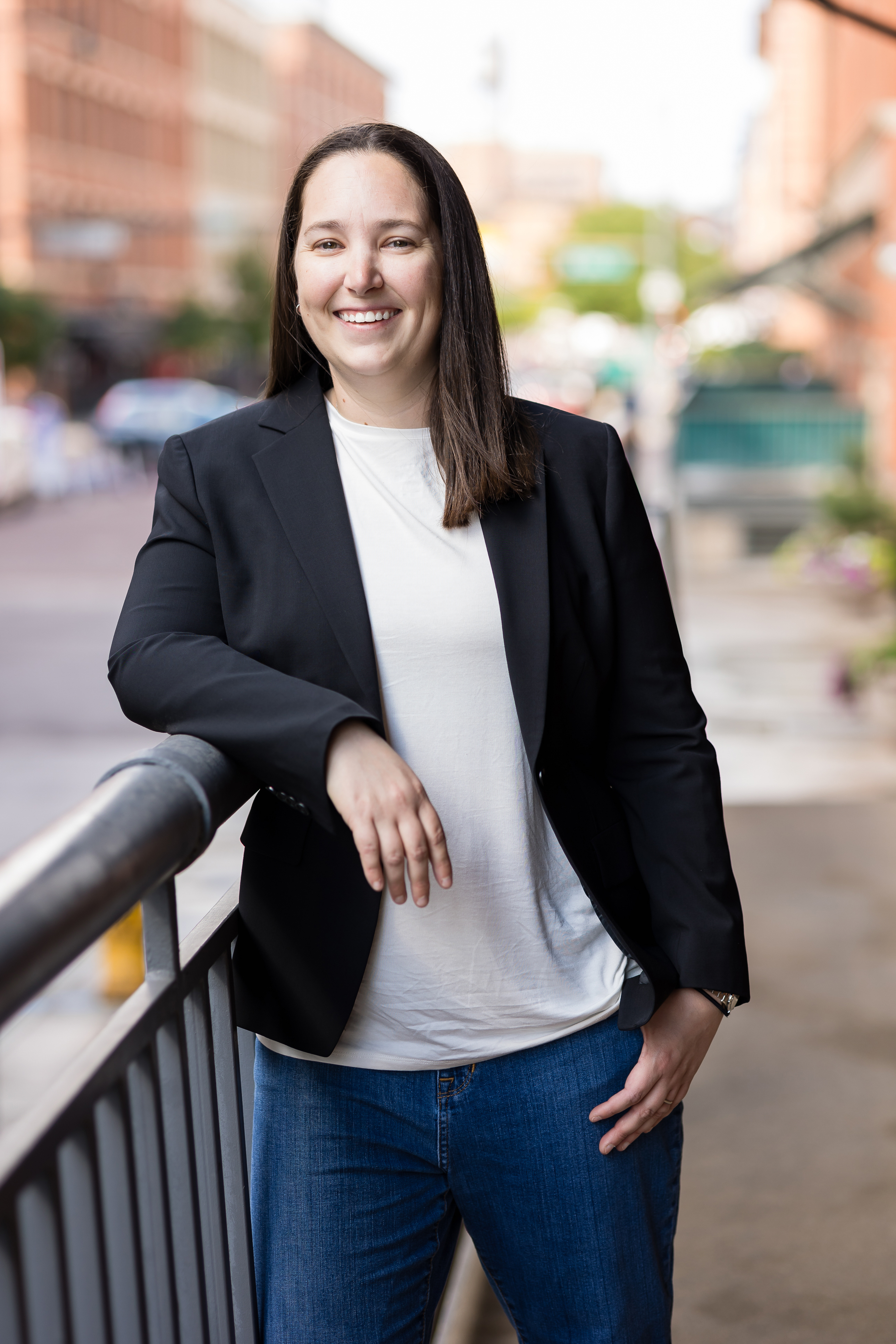 Amanda Diver in jeans and blazer with white shirt smiling at camera